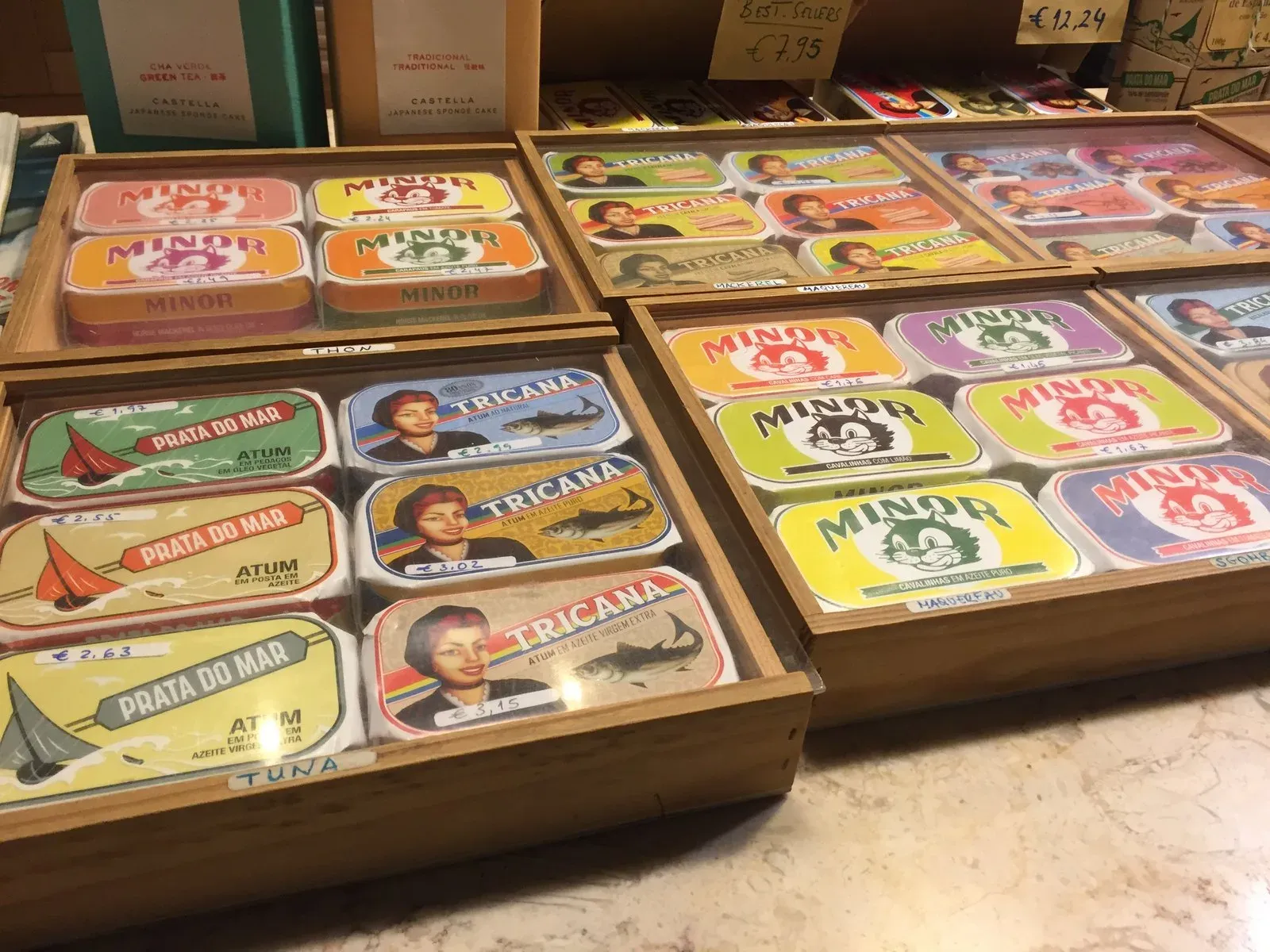 Trays of colourful Portuguese sardine tins with illustrated labels
