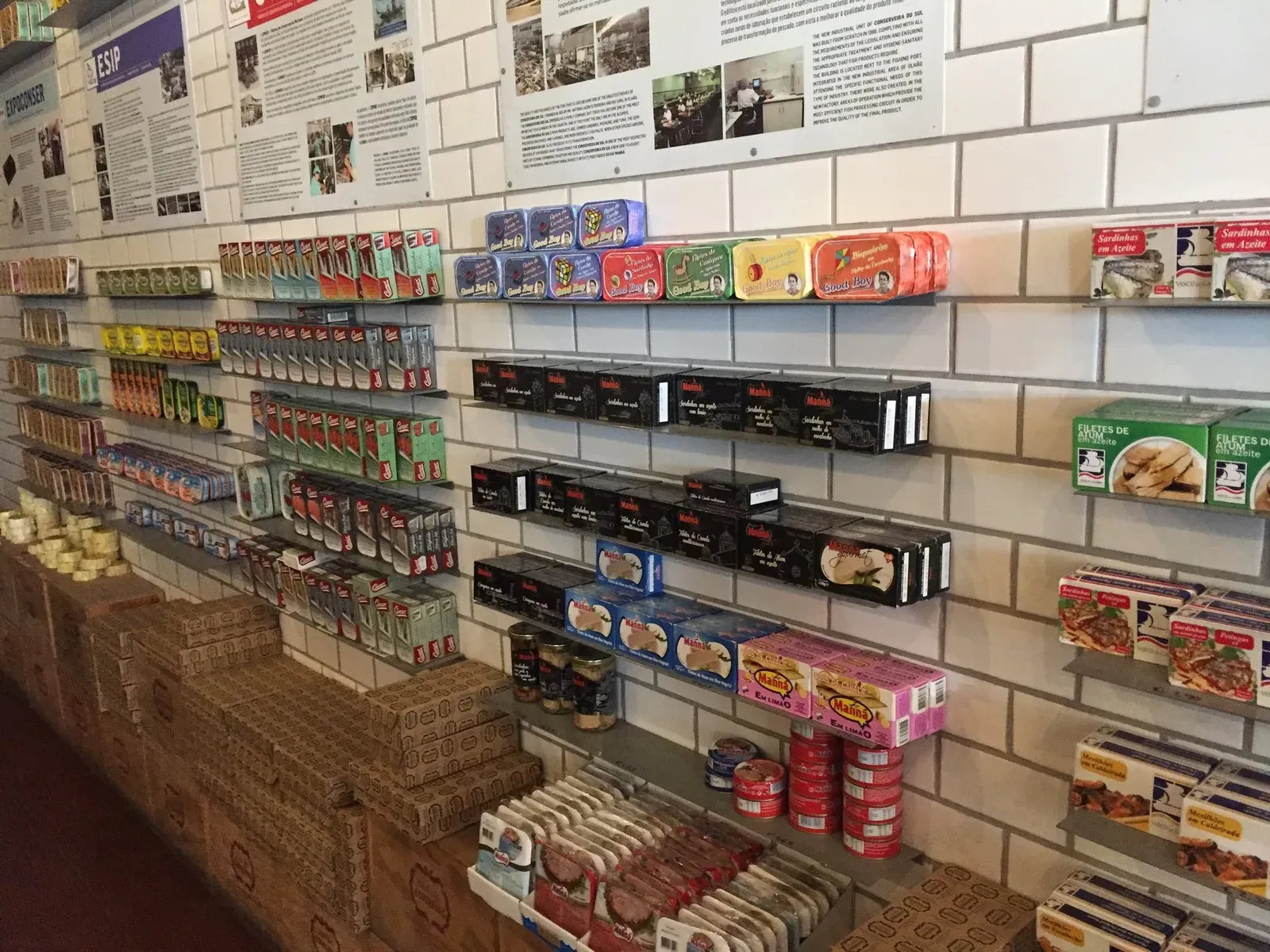 A wall of tinned fish on display rails in a Lisbon conserveira