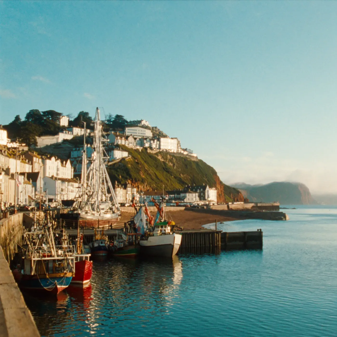 Illustrated coastal scene evoking United Kingdom — the home of Rockfish Tinned Seafood