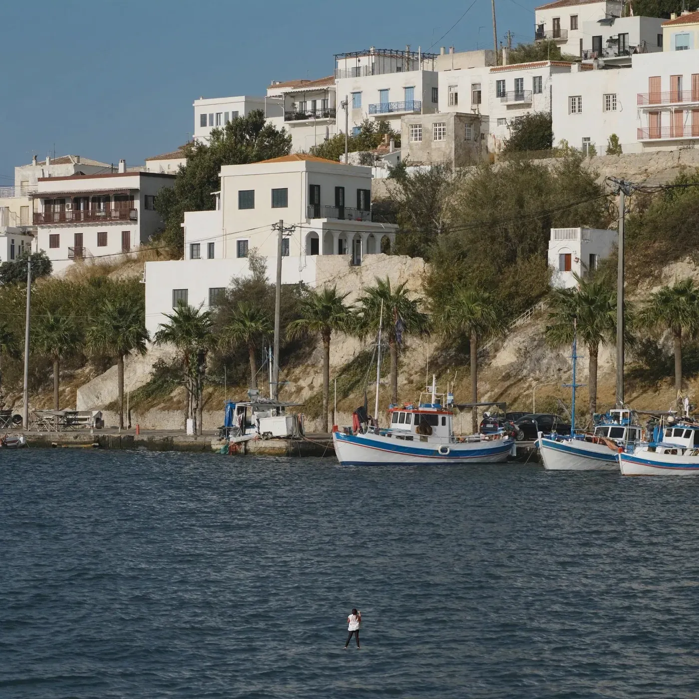 Illustrated coastal scene evoking Greece — the home of th!nkgreen Natural Goods